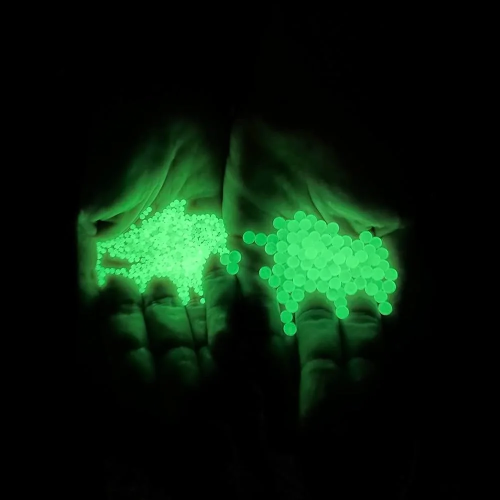 Glow – in – the – dark green water gel balls in hands